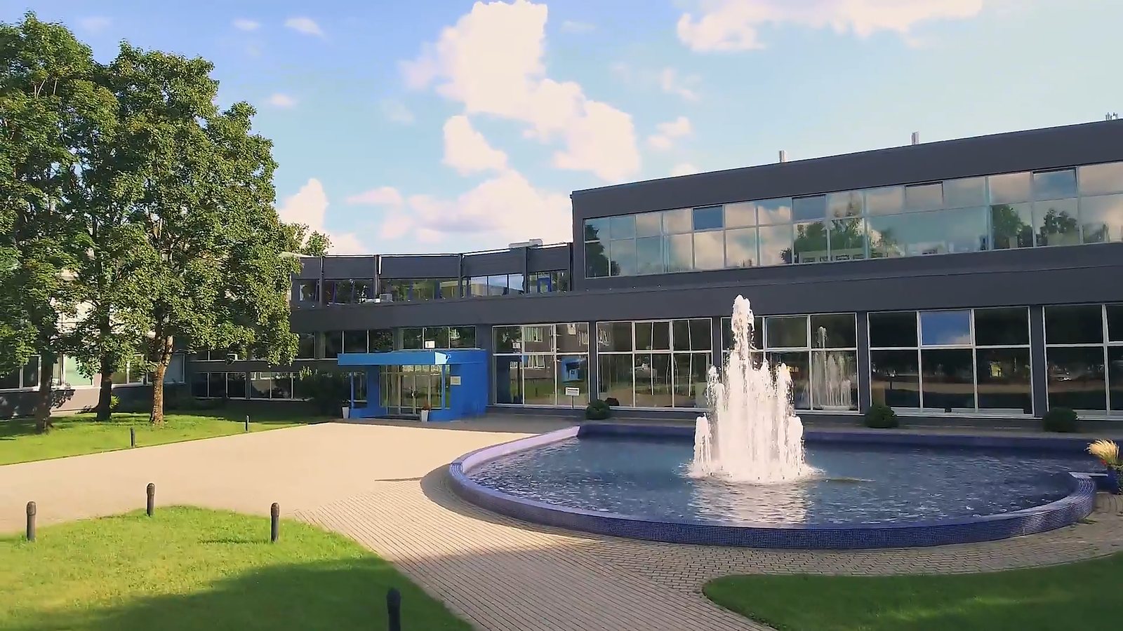The fountain in front of the glass-fronted main building at Turība